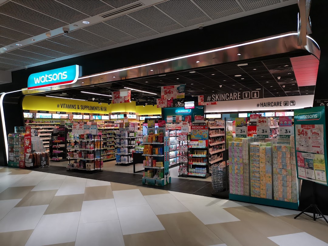 The brightly lit entrance of a Watsons store, showcasing health, beauty, and wellness products.