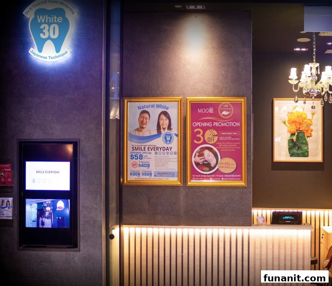 The shop front of White30 Teeth Whitening, featuring its illuminated logo and promotional posters.