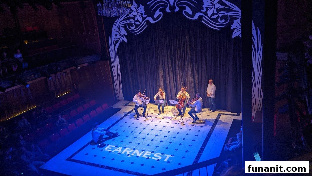 A live string quartet performs on stage at Wild Rice Funan theatre, with an audience watching.