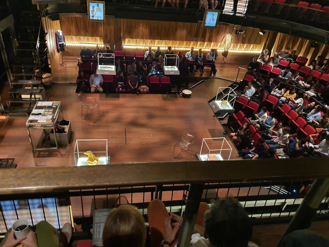 An overhead view of an audience seated in a theatre or event space with a stage area.