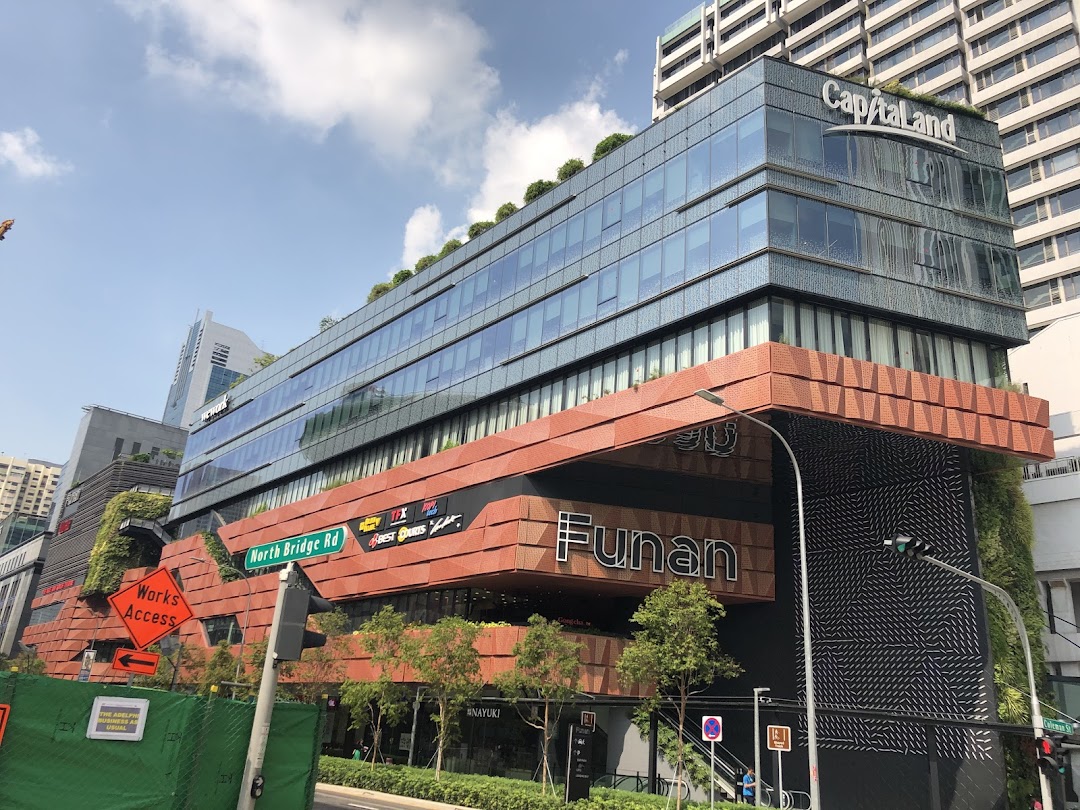 Exterior view of the modern Funan mall building with its distinctive architecture and green elements.