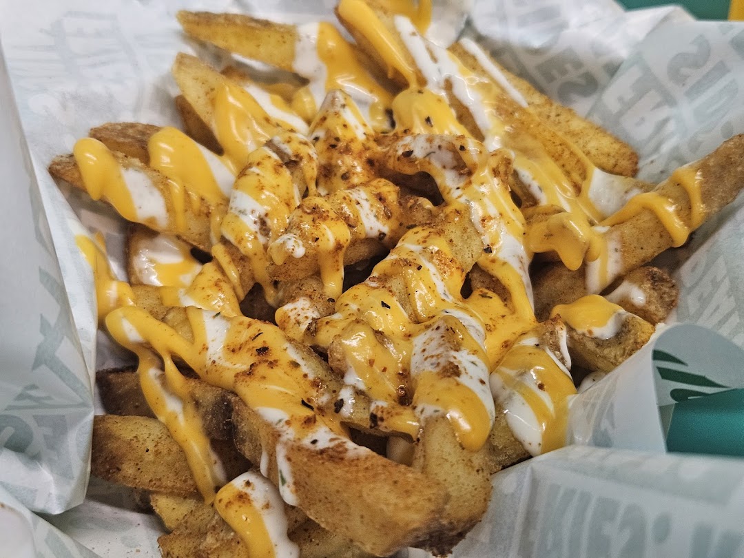 Delicious seasoned fries topped with creamy cheese and white sauces from Wingstop.