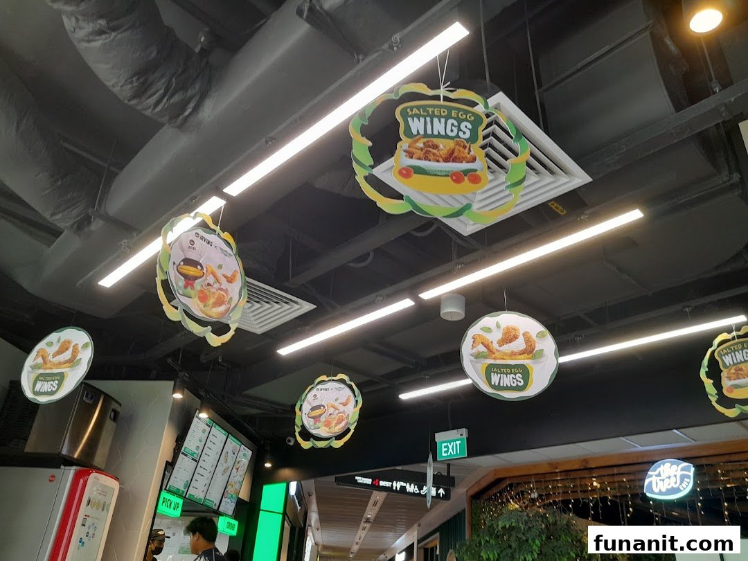 Interior view of Wingstop Funan featuring promotional signs for their popular Salted Egg Wings.