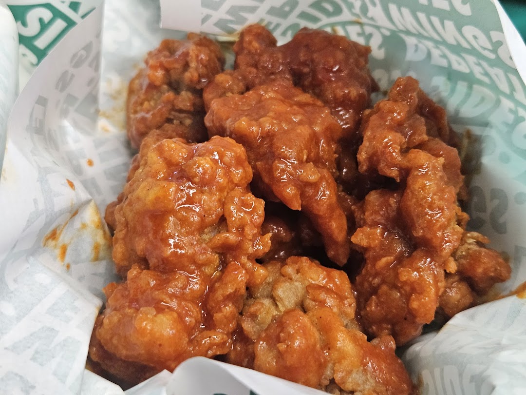 Close-up of delicious, saucy boneless chicken bites from Wingstop.