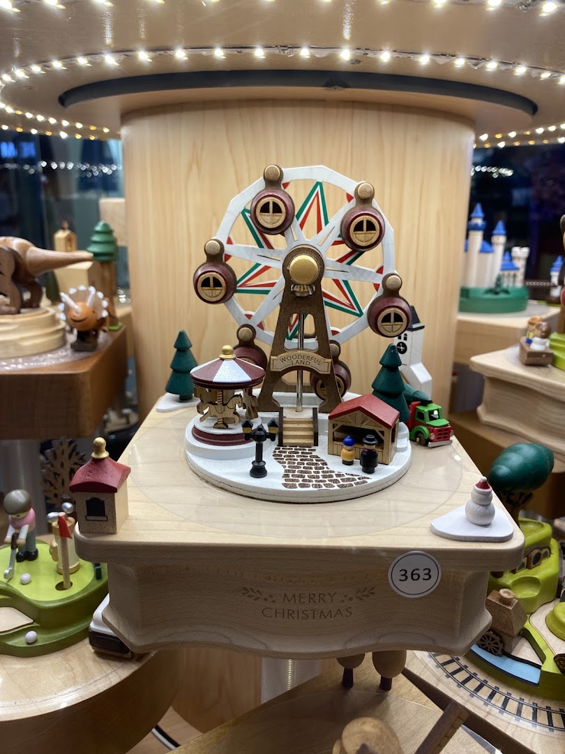 A detailed wooden Ferris wheel music box display with festive 'Merry Christmas' engraving.