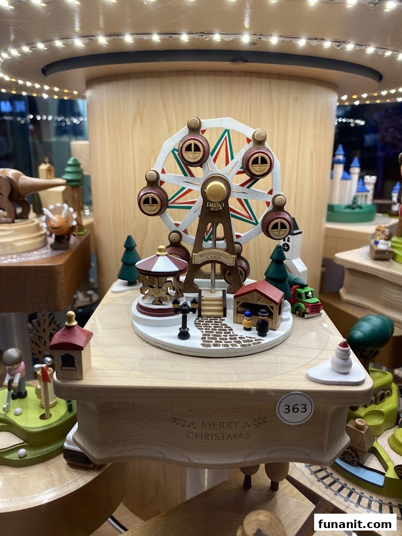 A detailed wooden Ferris wheel music box display with festive 'Merry Christmas' engraving.