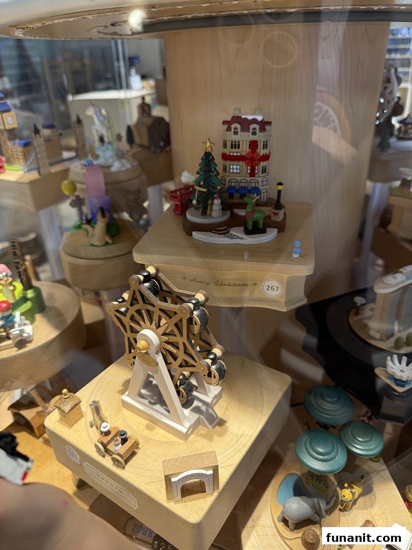 A close-up view of intricate wooden music boxes and crafts displayed in a glass case.