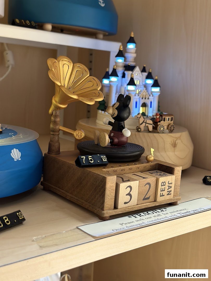 Close-up of a charming wooden Mickey Mouse music box with a gramophone and perpetual calendar.