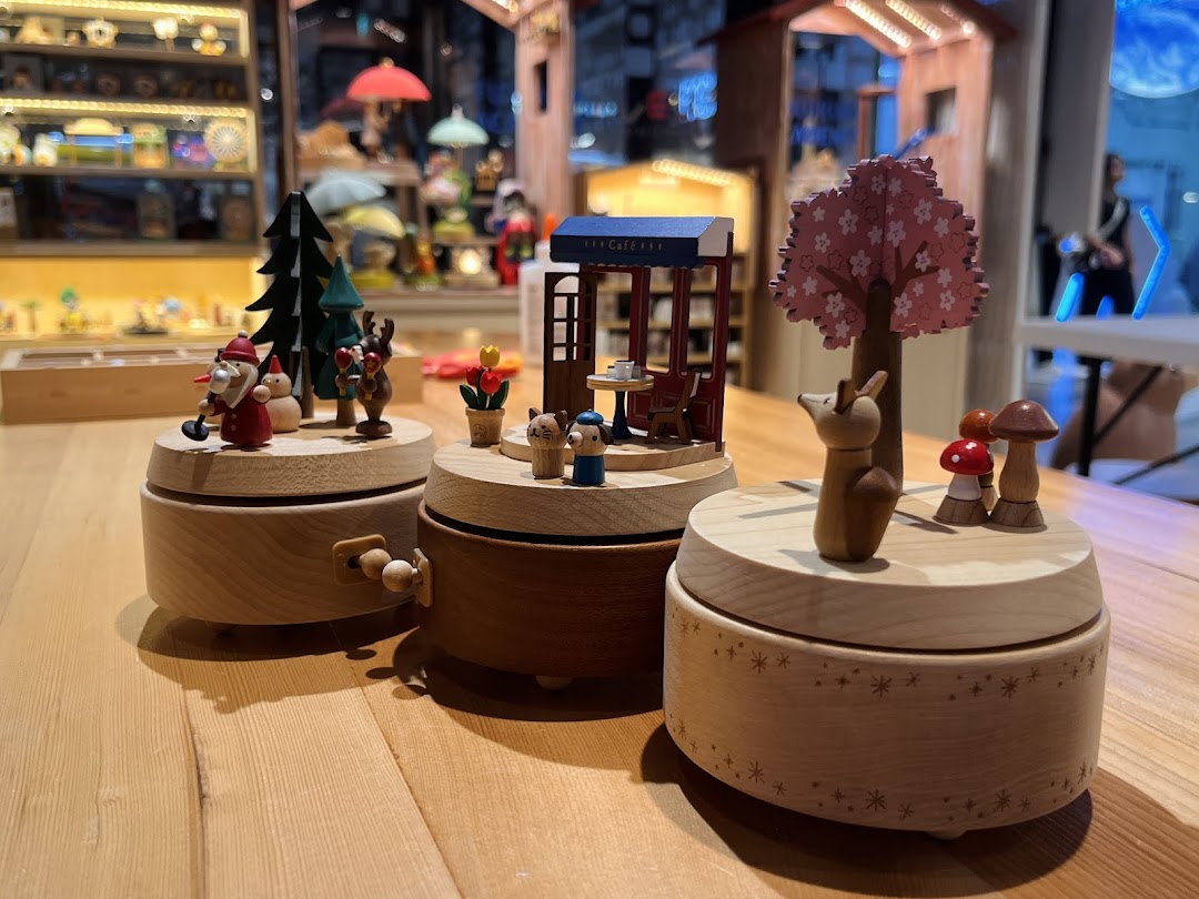 Close-up of charming wooden music boxes and figurines displayed inside Wooderful Life Singapore.