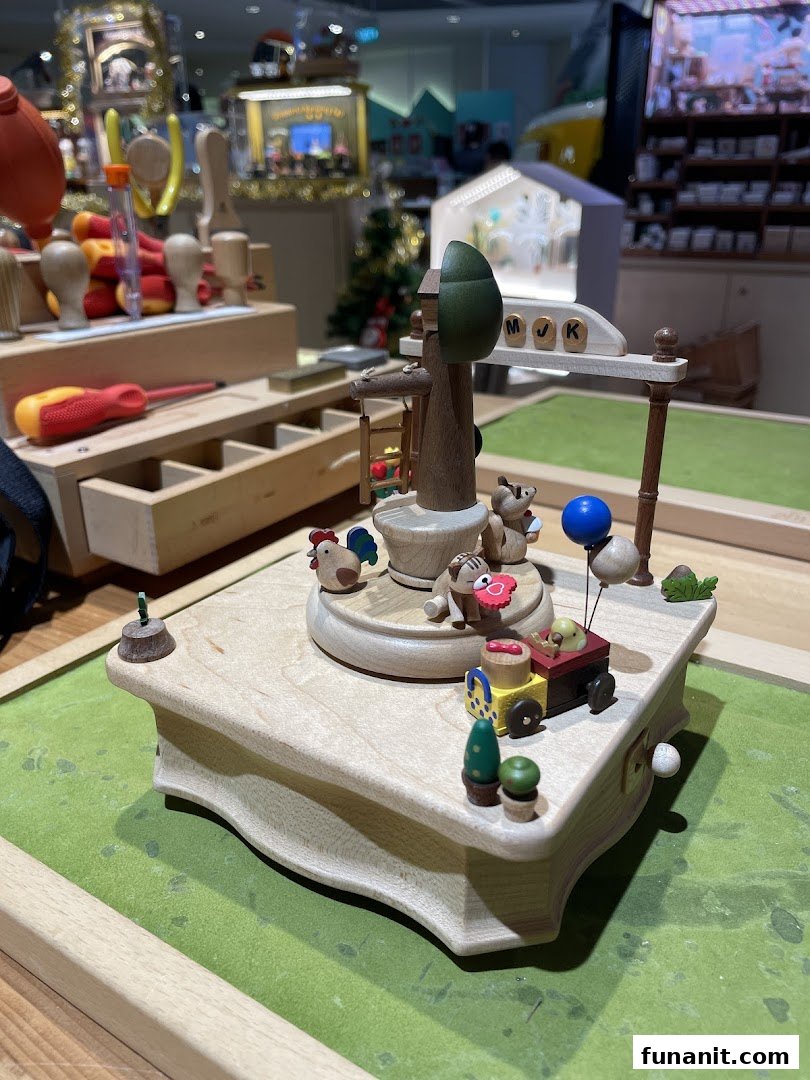 A detailed wooden music box or craft featuring charming animal figures and a miniature train.