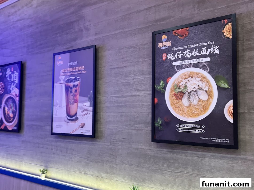 Promotional posters on a wall showcasing Signature Oyster Mee Sua and Brown Sugar Boba Fresh Milk.