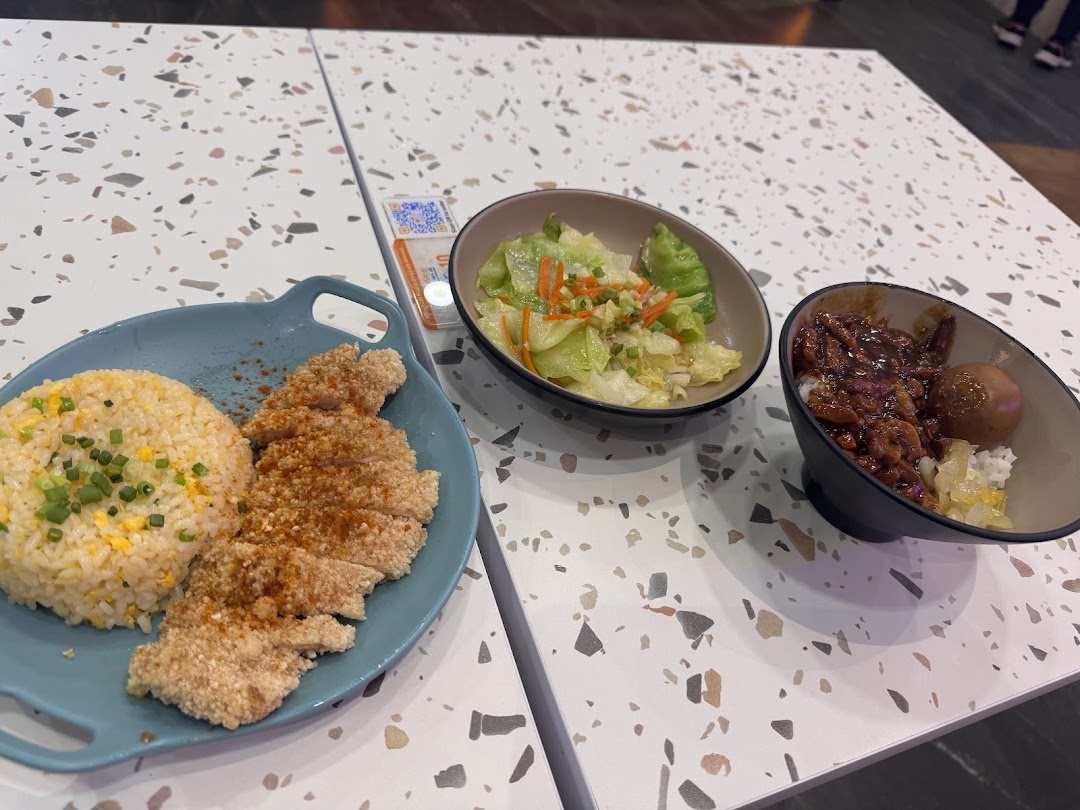 A delicious spread of Taiwanese fried chicken cutlet with fried rice, braised pork rice, and vegetables.