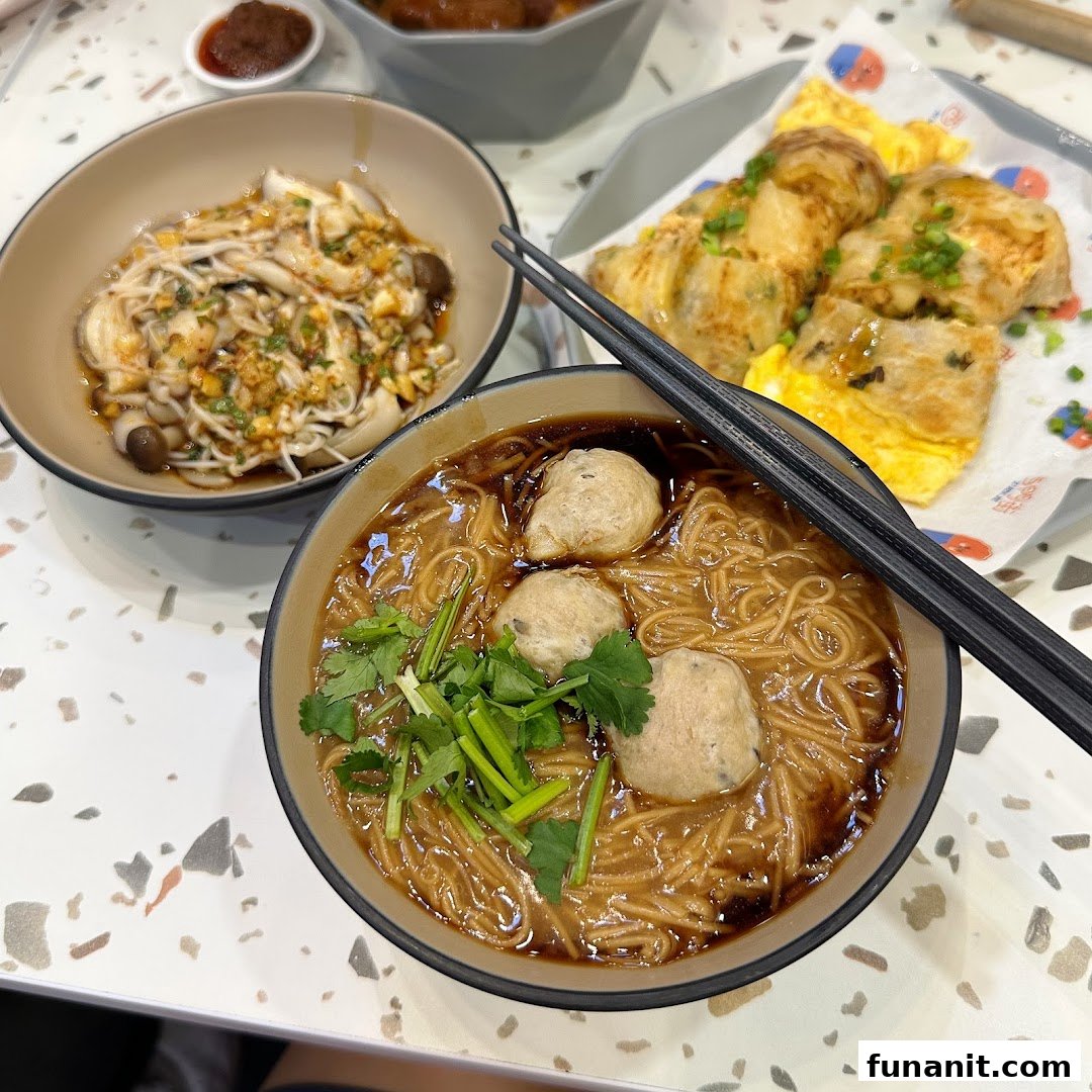A delicious spread of Taiwanese dishes including vermicelli with meatballs, mushrooms, and an egg crepe.
