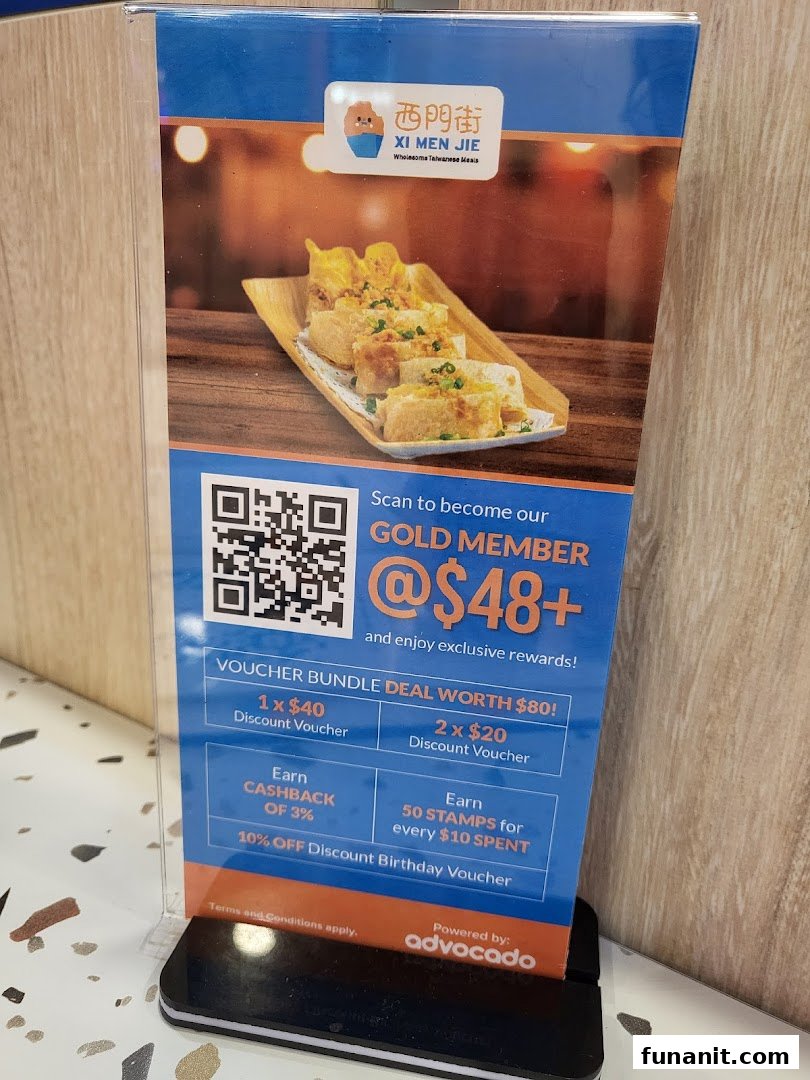 A promotional stand for Xi Men Jie's Gold Member program, showcasing membership benefits and delicious Taiwanese food.