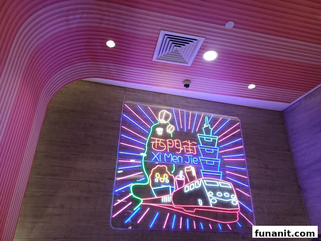 A vibrant neon sign featuring Taiwanese landmarks and a train, illuminating the shop's interior.