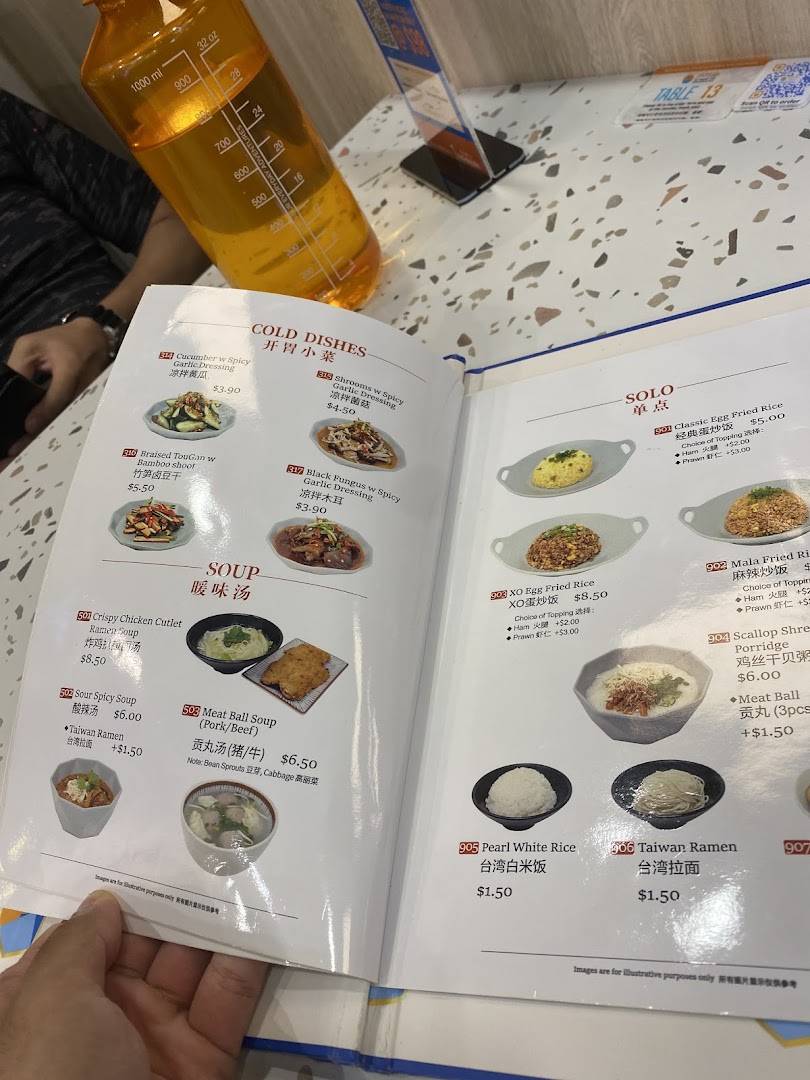 A detailed menu displaying various Taiwanese cold dishes, soups, and solo meals with prices.
