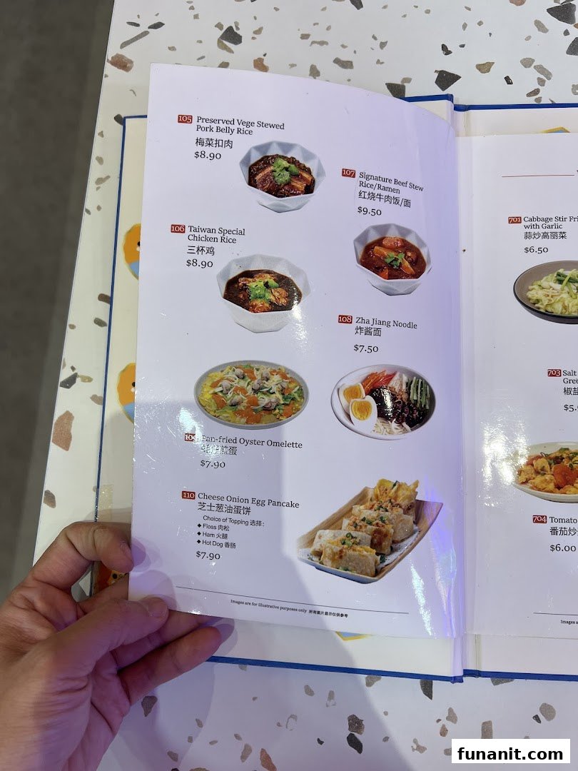 A close-up of a menu page from Xi Men Jie, showcasing various Taiwanese dishes with prices.