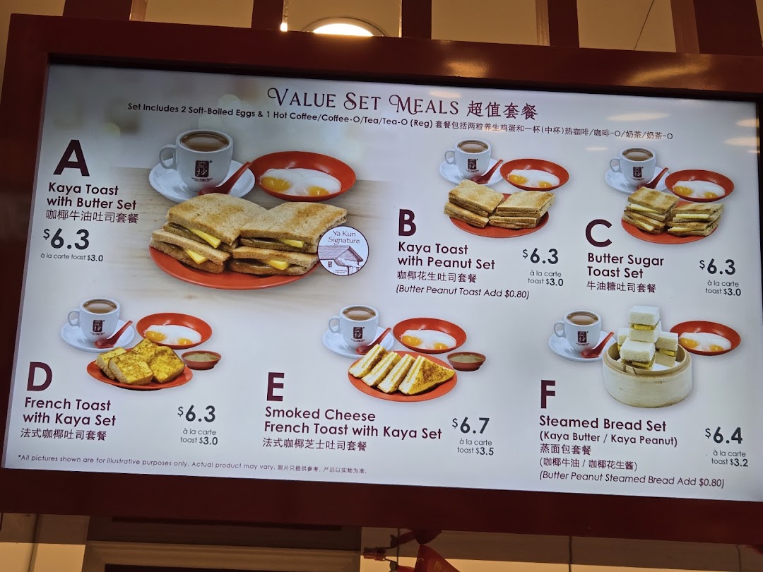 A digital menu board displaying various value set meals with toast, eggs, and drinks at Ya Kun Kaya Toast.