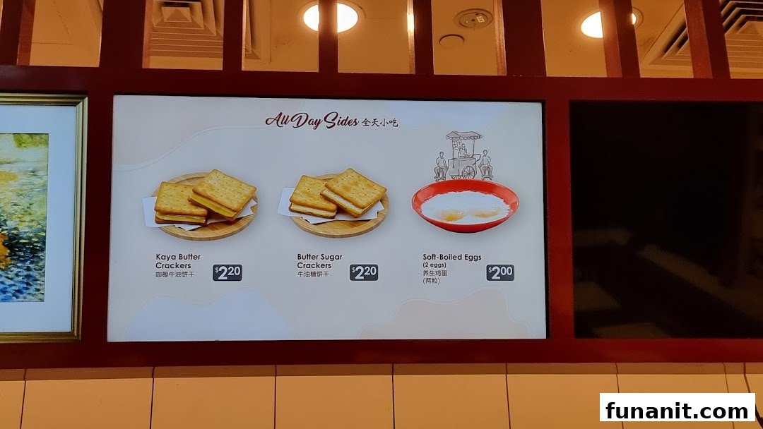 A digital menu board from Ya Kun Kaya Toast displaying all-day side dishes with prices.