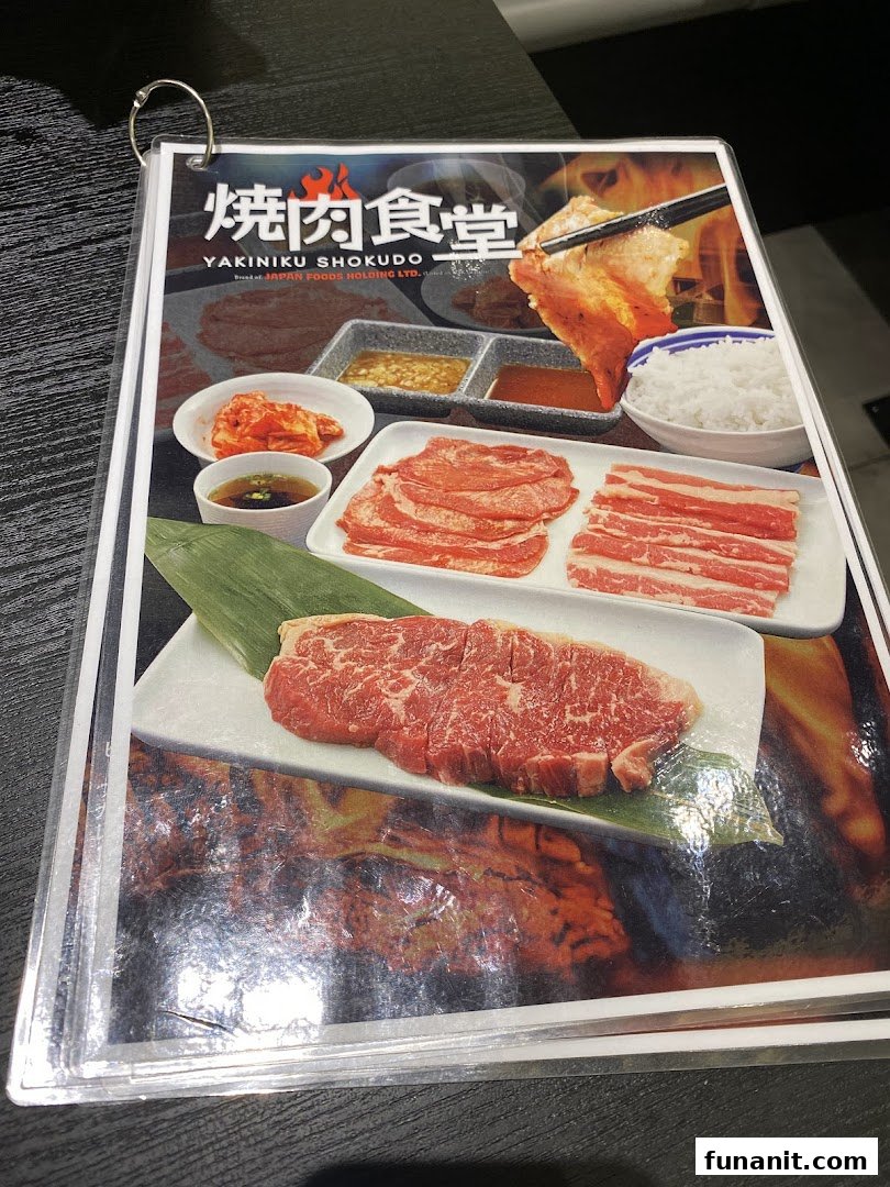 A vibrant menu page from Yakiniku Shokudo showcasing various cuts of raw meat, sides, and sauces.