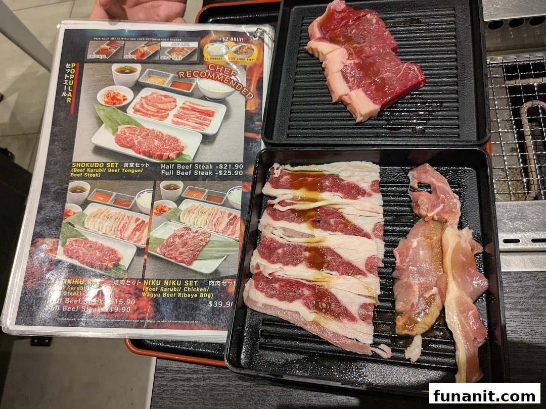 Menu displaying yakiniku meat sets and raw beef/chicken cuts on trays for grilling.