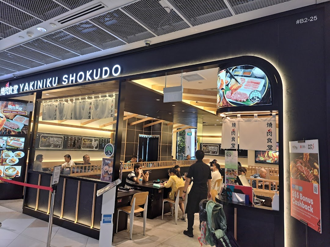 The vibrant storefront of Yakiniku Shokudo, a Japanese BBQ restaurant, with diners enjoying their meals.
