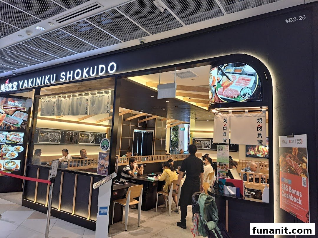 The vibrant storefront of Yakiniku Shokudo, a Japanese BBQ restaurant, with diners enjoying their meals.