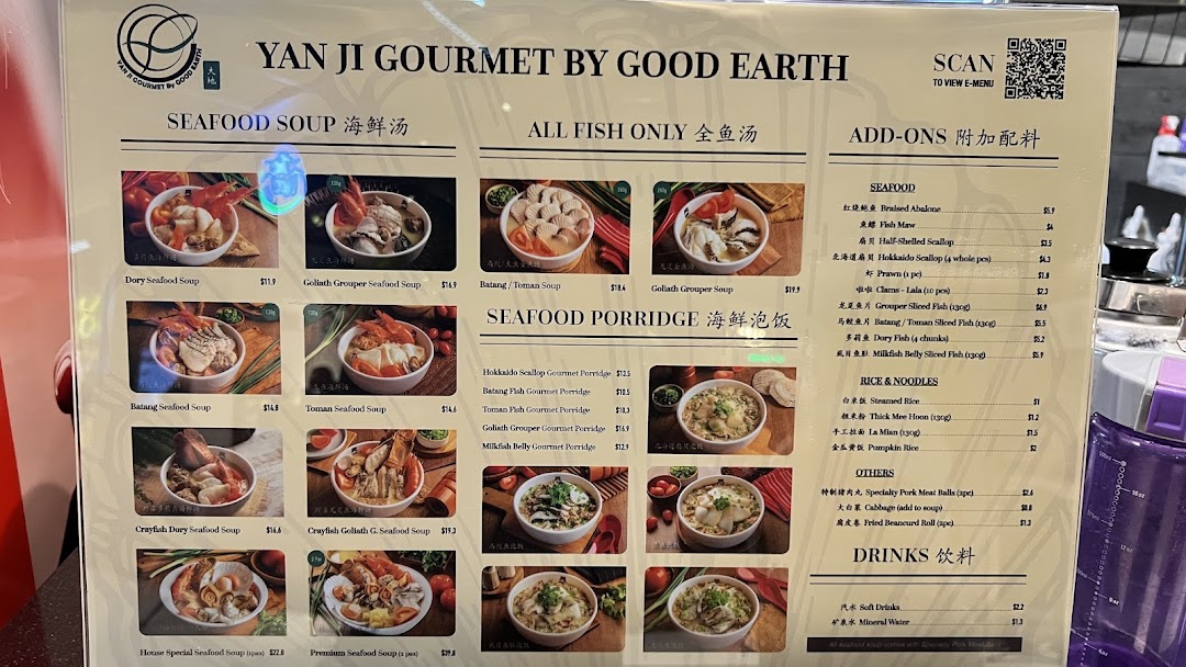 A detailed menu board displaying seafood soups, porridges, and add-ons with prices from Yan Ji Gourmet.