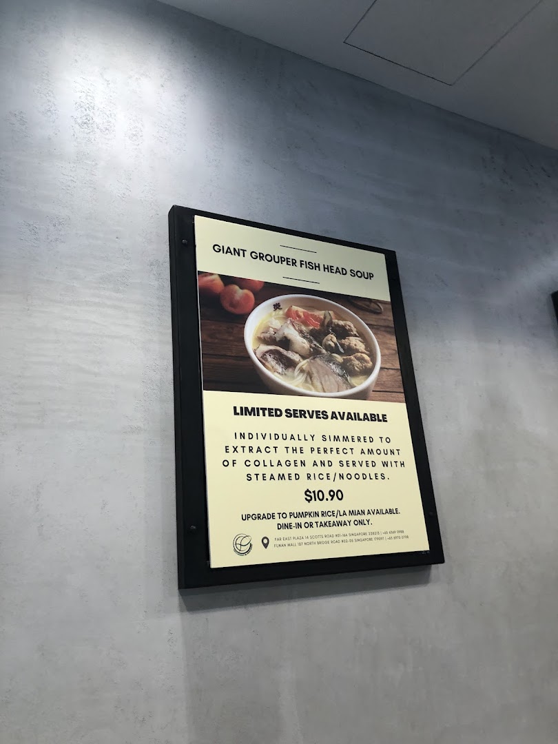 A display board featuring the Giant Grouper Fish Head Soup with its price and description.