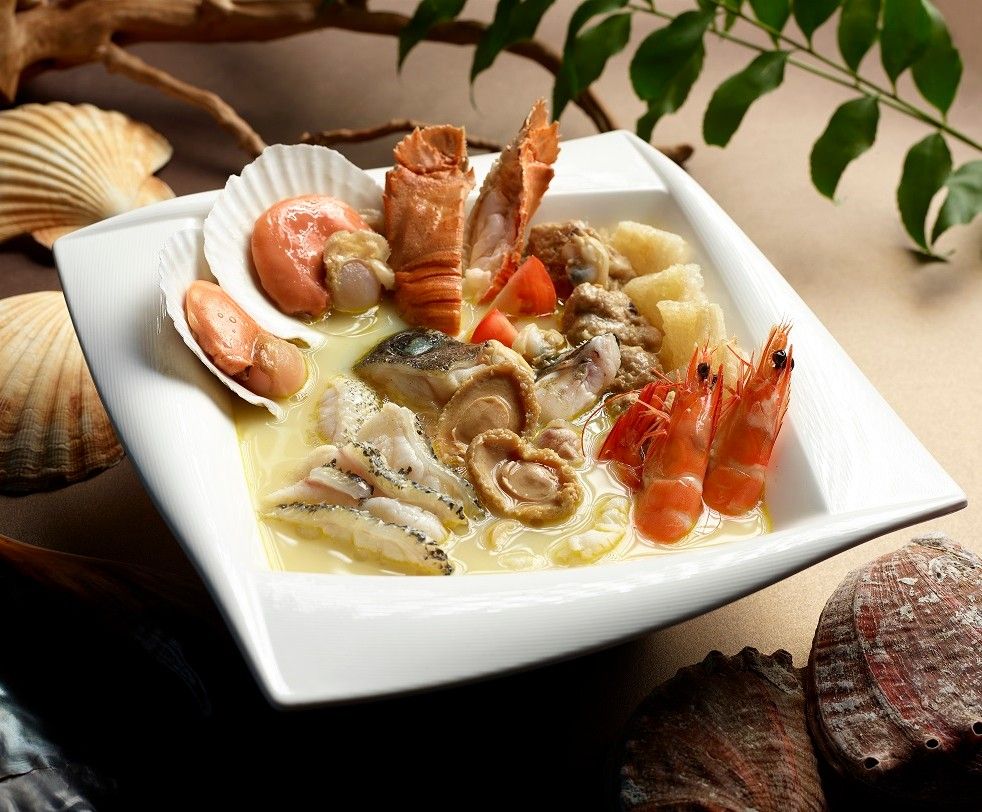 A rich seafood soup featuring prawns, scallops, abalone, fish, and lobster in a creamy broth.
