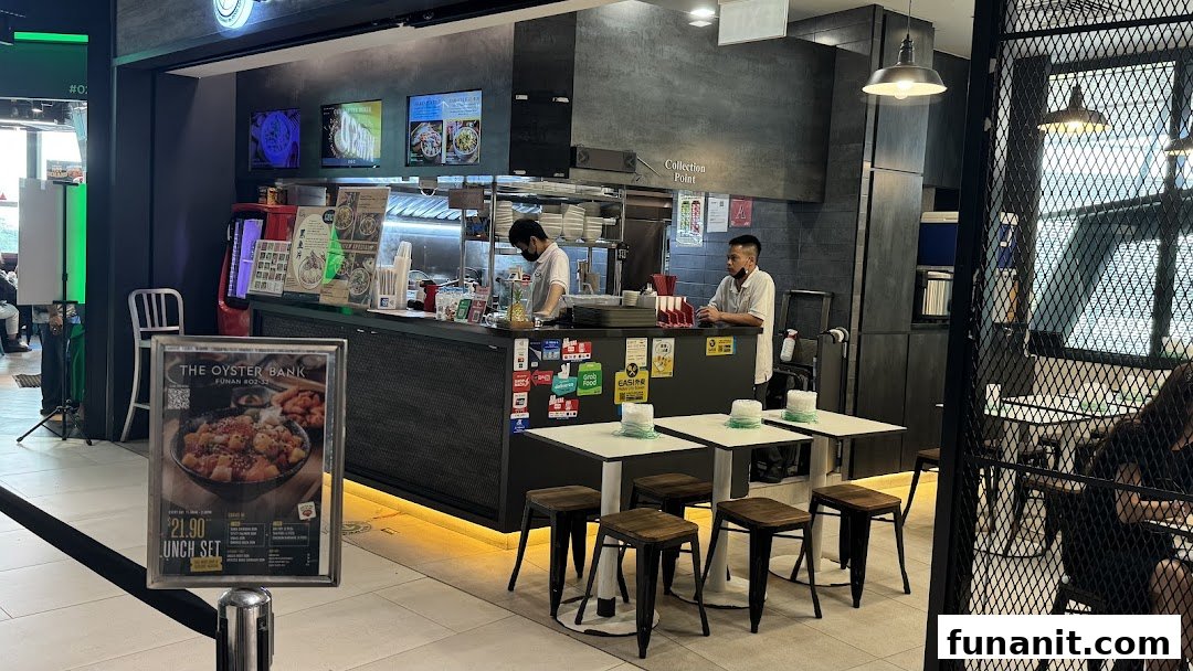 An interior view of Yan Ji Gourmet Seafood Soup, showing the counter, staff, and dining area.