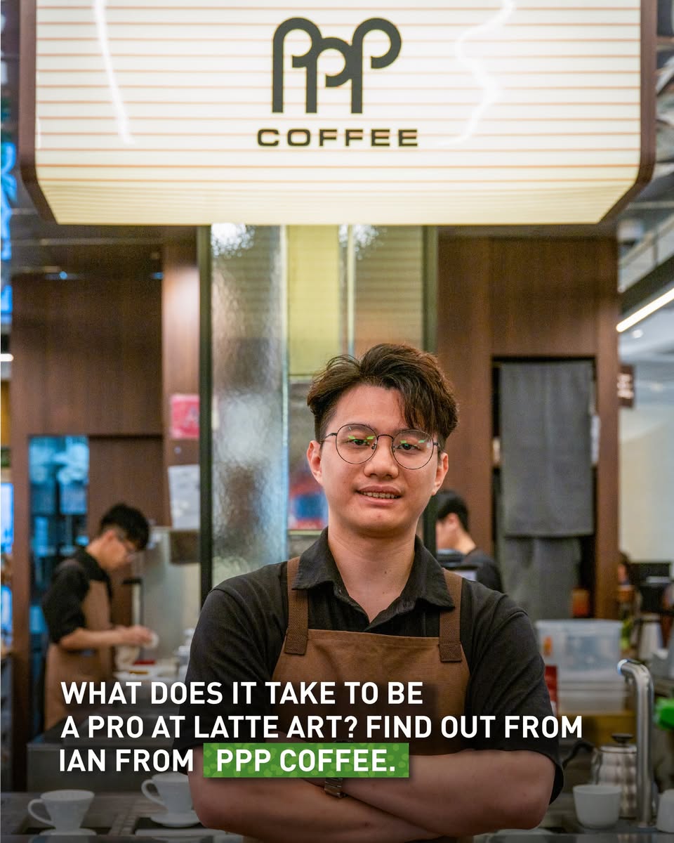 Barista Ian focused on pouring milk for latte art