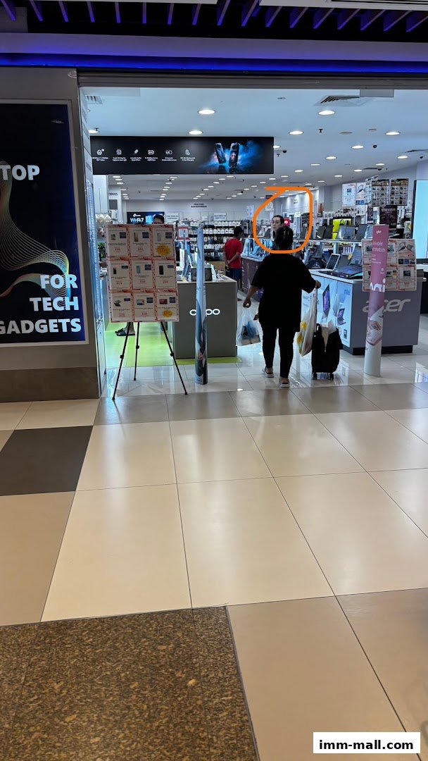 Interior view of a Challenger electronics store with various gadgets and displays.