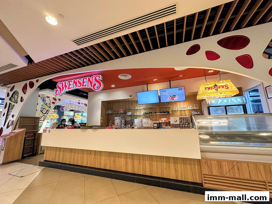 The Swensen's ice cream shop counter with staff and display cases.