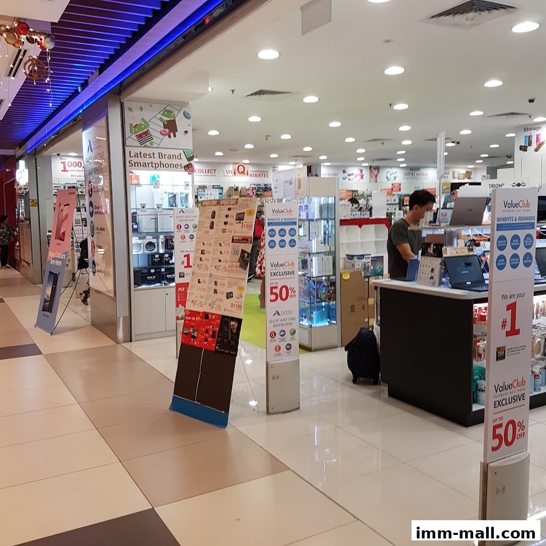 Interior view of a Challenger electronics store with various product displays and promotional stands.