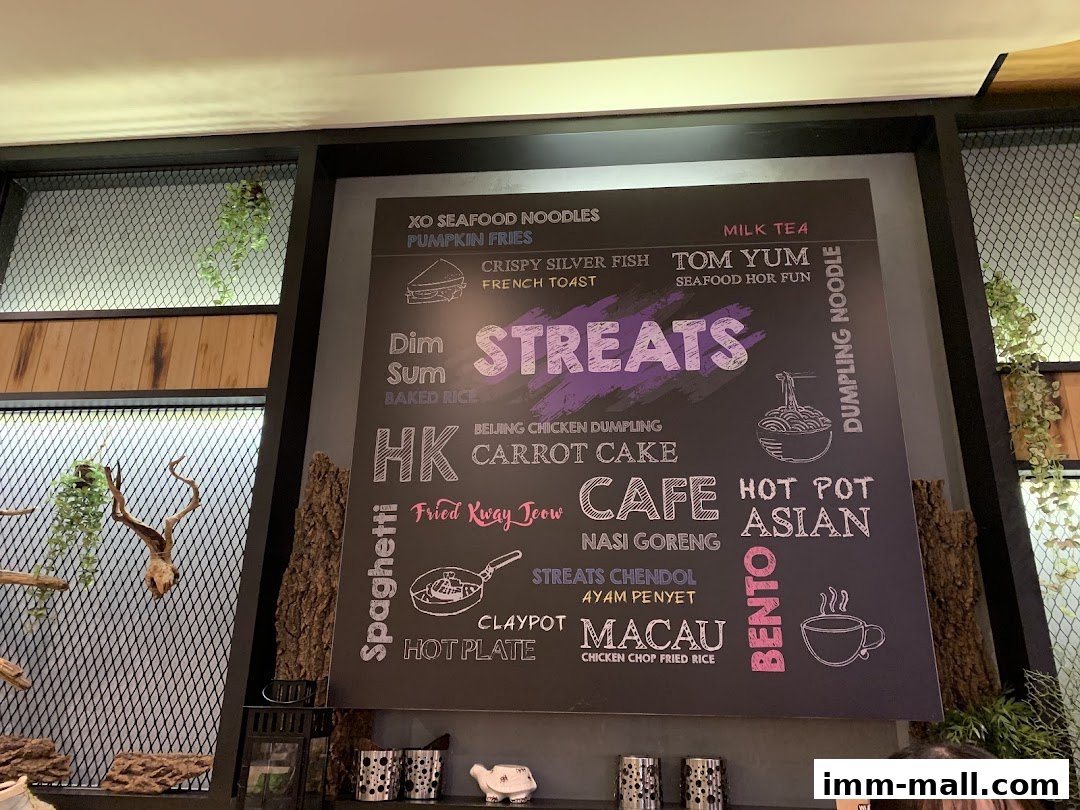 A menu board displays various food and drink items offered at Streats IMM.