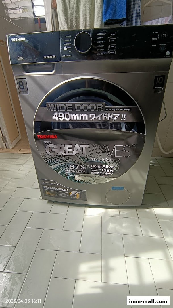 A Toshiba washing machine with a wide door and 'The Great Waves' technology.