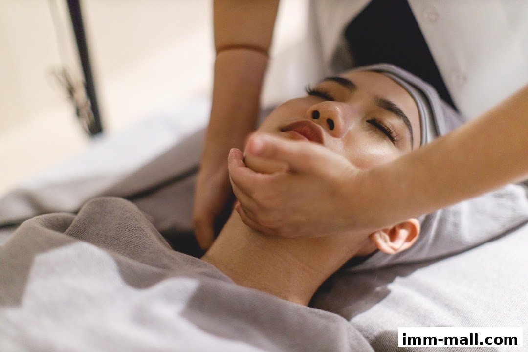 A person receiving a facial massage at a beauty salon.