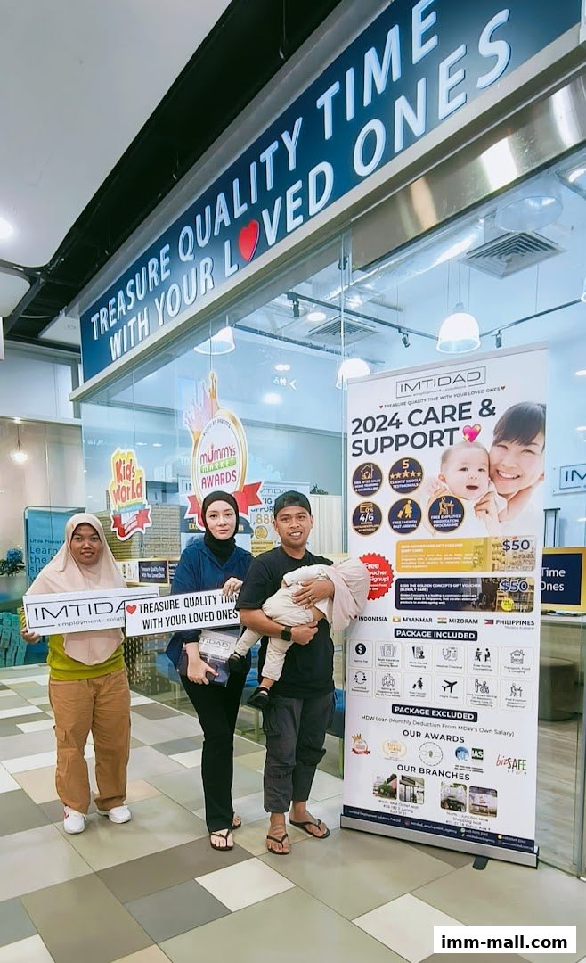 A family poses with staff in front of a promotional banner for Imtidad.