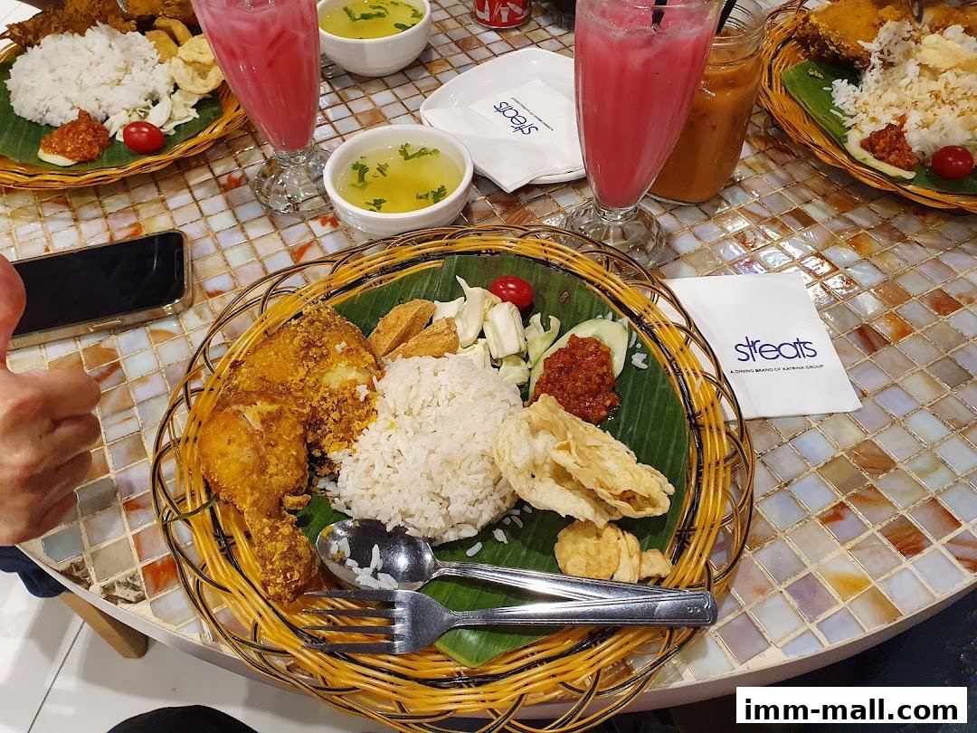 A table setting with two meals, drinks, and soup, featuring fried chicken and rice.