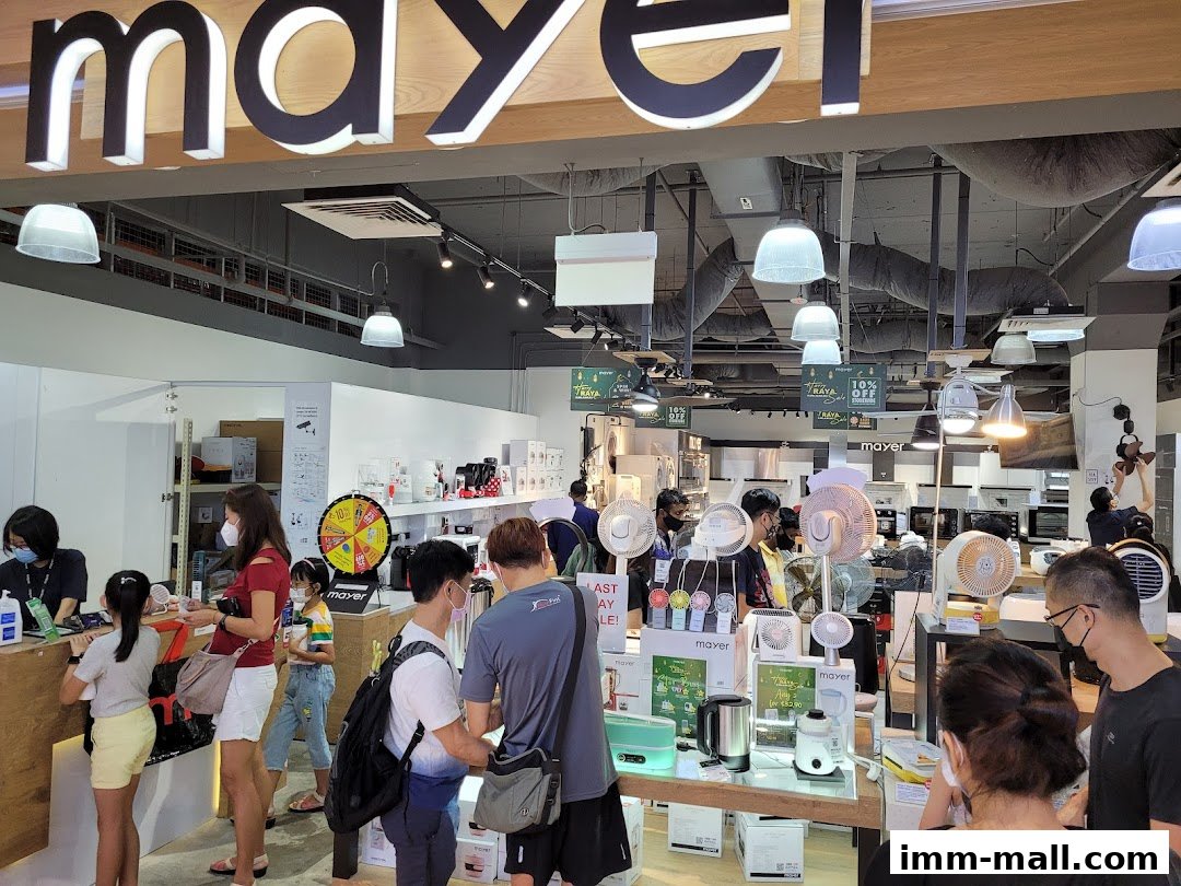 Customers browse appliances at the Mayer Showroom IMM Building, with a variety of fans and kitchenware on display.