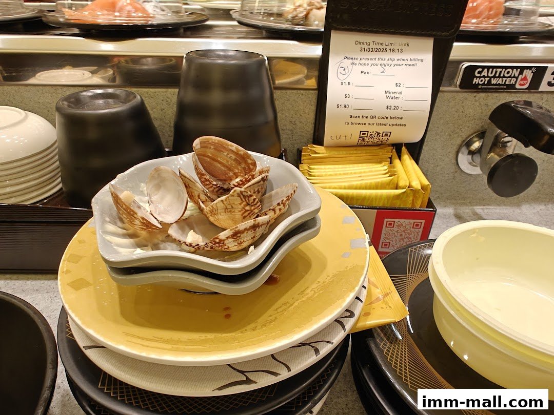 A close-up of used sushi plates and a dining slip at Sushi Express.