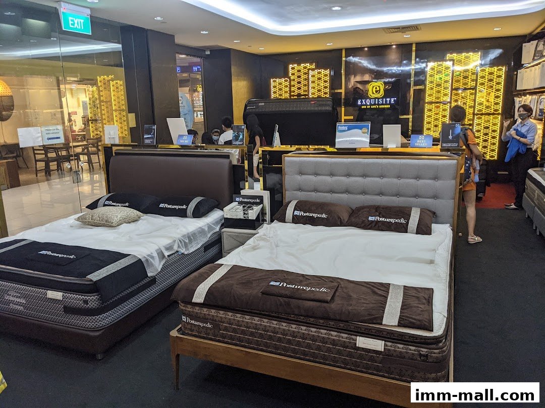 Interior of a Sealy Sleep Boutique showcasing Posturepedic beds and a woman browsing.