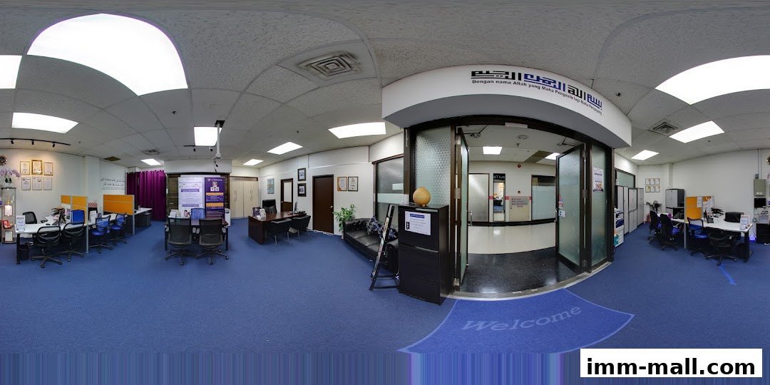 Interior view of an office space with desks, chairs, and a reception area.