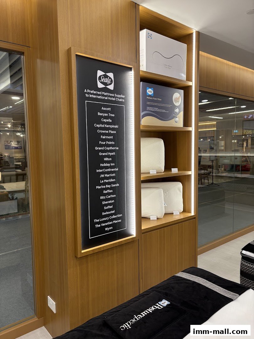 Sealy Sleep Boutique interior showcasing mattresses, pillows, and a list of hotel clients.