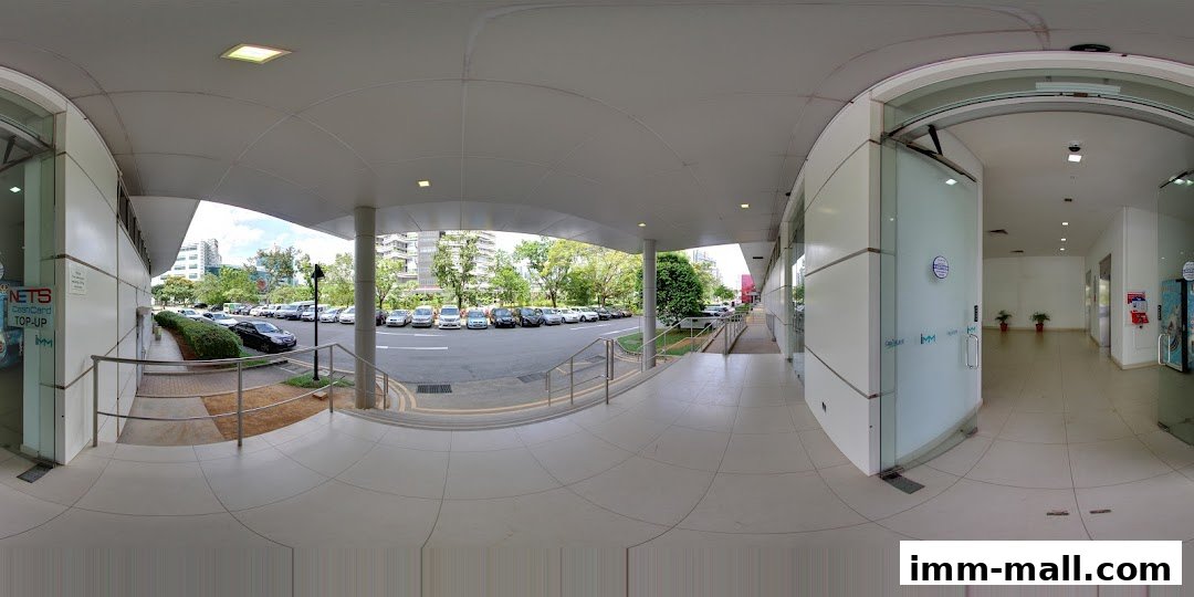 Exterior view of a shop entrance with a parking lot and trees visible.