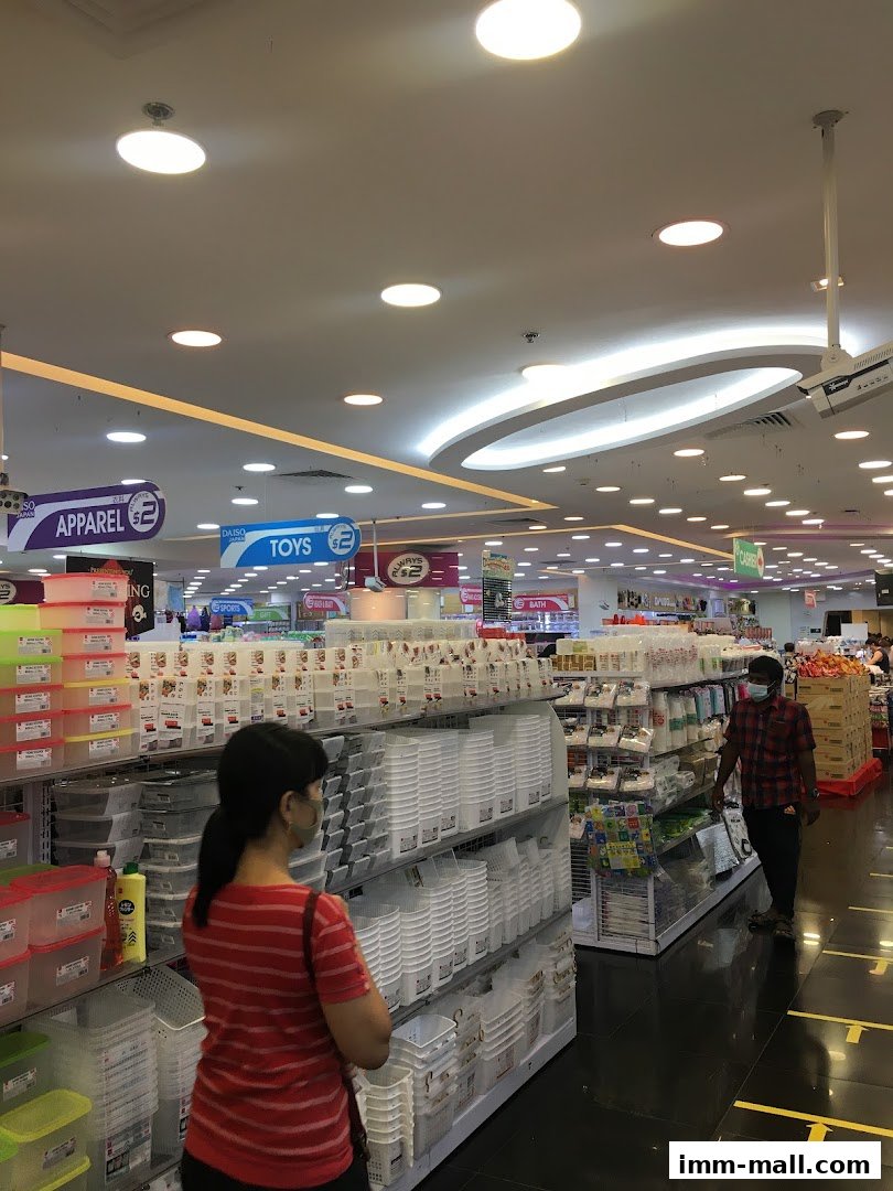 Interior view of a DAISO store with aisles of storage containers and various products.