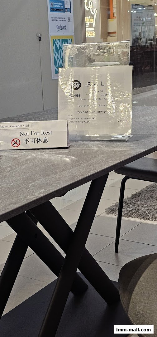 A dining table with a sale sign and a 'Not For Rest' sign on it.