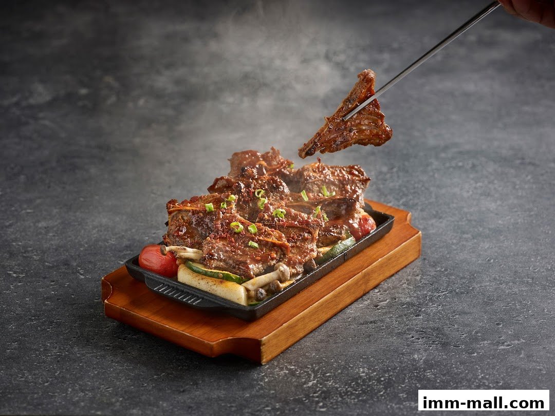 A sizzling plate of Korean BBQ ribs with vegetables, served on a cast iron skillet.