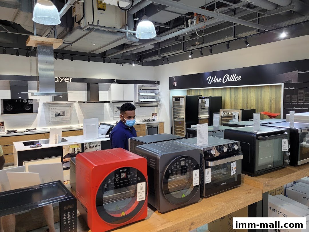 Interior view of a Mayer showroom displaying kitchen appliances like ovens and wine chillers.